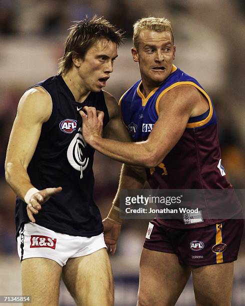 Michael Voss of the Lions jostles for position with Bret Thornton of the Blues during the round 13 AFL match between the Brisbane Lions and Carlton...