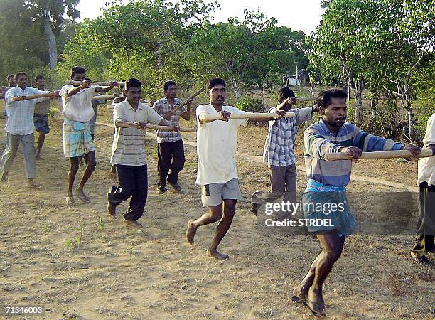 Tamil civilians get soldier training on the outskirts of Kilinochchi, 328 kilometers north of the country's main city Colombo, 30 June 2006. Sri...