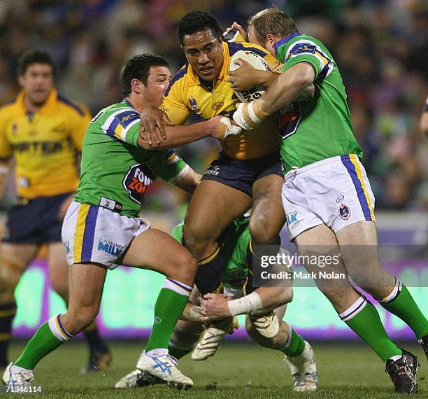 Fuifui Moimoi of the Eels is tackled during the round 17 NRL match between the Canberra Raiders and the Parramatta Eels played at Canberra Stadium on...