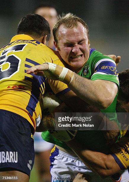 Micheal Weyman of the Raiders is tackled during the round 17 NRL match between the Canberra Raiders and the Parramatta Eels played at Canberra...