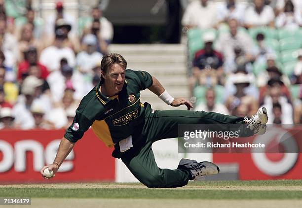 Andy Bichel of Essex makes an acrobatic stop during the Twenty20 Cup match between Surrey and Essex at the Brit Oval on July 1, 2006 in London,...