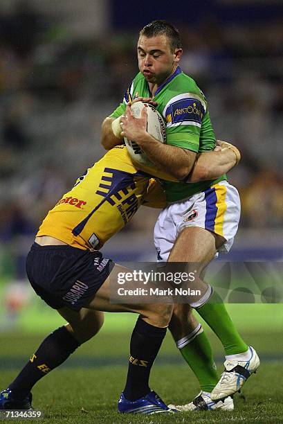 Marshall Chalk of the Raiders is tackled during the round 17 NRL match between the Canberra Raiders and the Parramatta Eels played at Canberra...