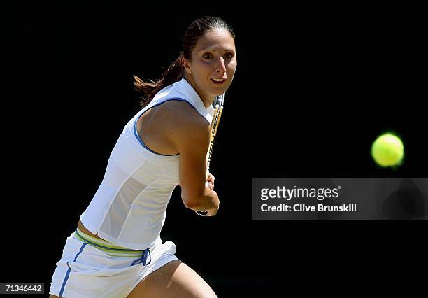 Anastasia Myskina of Russia returns a backhand to Anabel Medina Garrigues of Spain during day six of the Wimbledon Lawn Tennis Championships at the...
