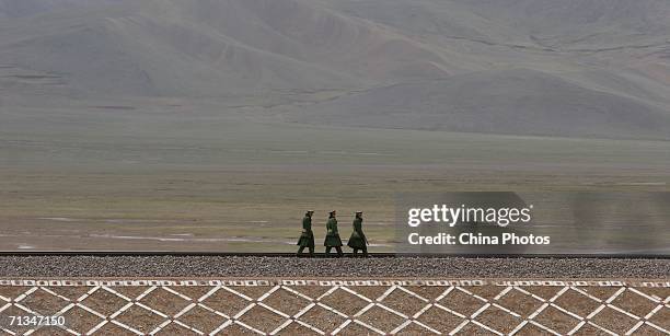 Railway policemen patrol along the Qinghai-Tibet Railway on June 30, 2006 in Golmud of Qinghai Province, China. The Qinghai-Tibet railway will begin...