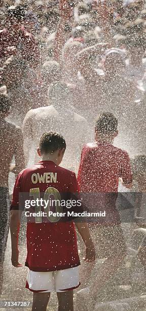 England football supporters get a soaking from a fire hose at the Fan Fest on July 1, 2006 in Gelsenkirchen, Germany.