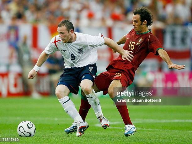 Wayne Rooney of England holds off Ricardo Carvalho of Portugal during the FIFA World Cup Germany 2006 Quarter-final match between England and...