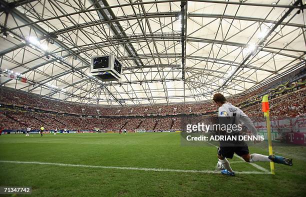 Gelsenkirchen, GERMANY: English midfielder David Beckham shoots a corner kick during the World Cup 2006 quarter final football game England vs....