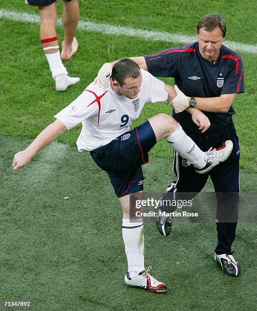 Wayne Rooney of England is restrained after being sent off during the FIFA World Cup Germany 2006 Quarter-final match between England and Portugal...