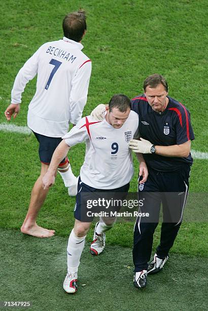 Wayne Rooney of England is restrained after being sent off during the FIFA World Cup Germany 2006 Quarter-final match between England and Portugal...