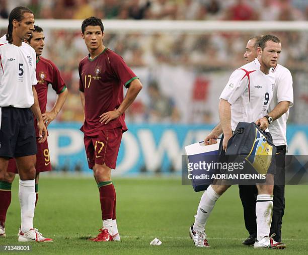 Gelsenkirchen, GERMANY: English forward Wayne Rooney leaves the pitch after his red card next to Portuguese forward Cristiano Ronaldo during the...