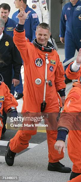 Mission Specialist Piers Sellers of the United Kingdom walks out of the Operations and Checkout building and into the astrovan for transport to Space...