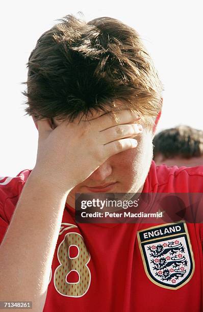An England football fan holds his hand to his face at the Fan Fest on July 1, 2006 in Gelsenkirchen, Germany. England are playing Portugal in the...
