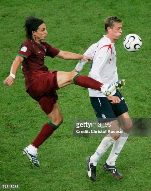 Peter Crouch of England battles for the ball with Fernando Meira of Portugal during the FIFA World Cup Germany 2006 Quarter-final match between...