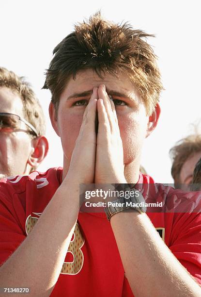 An England football fan holds his hands to his face at the Fan Fest on July 1, 2006 in Gelsenkirchen, Germany. England are playing Portugal in the...