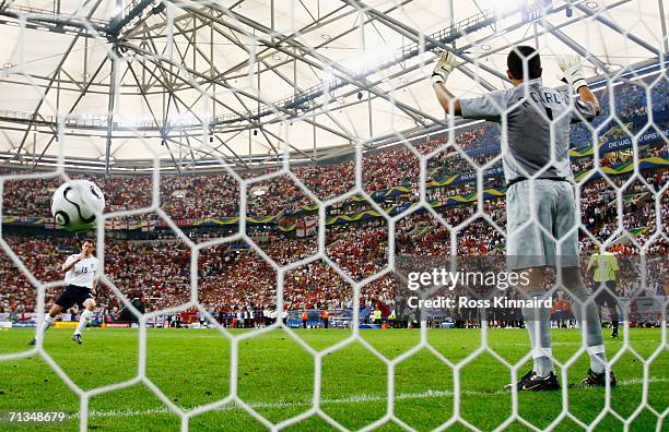 Jamie Carragher of England takes a penalty which he is made to retake as Ricardo of Portugal gestures in a penalty shootout during the FIFA World Cup...