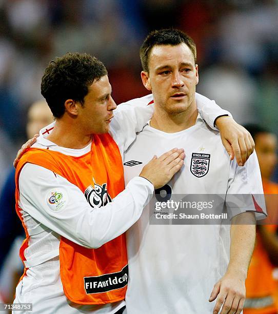 Wayne Bridge consoles England team mate John Terry following defeat during the FIFA World Cup Germany 2006 Quarter-final match between England and...