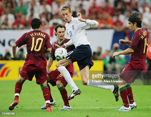 Peter Crouch of England is pressurised by Hugo Viana , Ricardo Carvalho and Nuno Valente of Portugal during the FIFA World Cup Germany 2006...