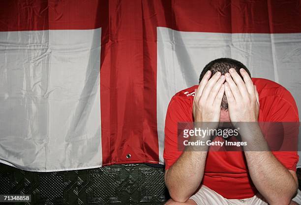 An English football supporter reacts as their team lose on penalties during the FIFA World Cup quarter final match with Portugal on July 1, 2006 in a...