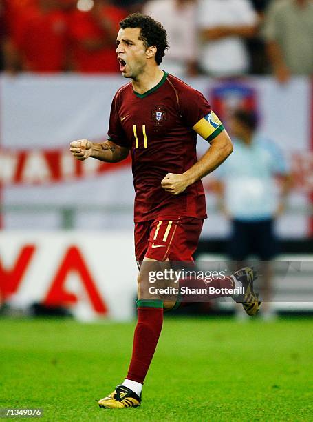 Simao Sabrosa of Portugal celebrates scoring a penalty in a penalty shootout during the FIFA World Cup Germany 2006 Quarter-final match between...