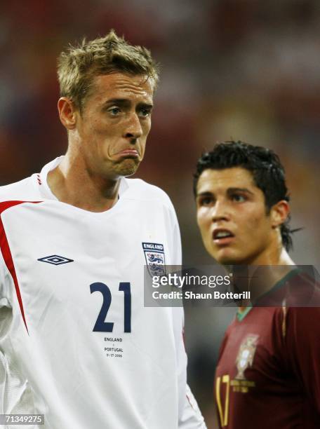 Peter Crouch of England pulls a face as Cristiano Ronaldo of Portugal looks on during the FIFA World Cup Germany 2006 Quarter-final match between...