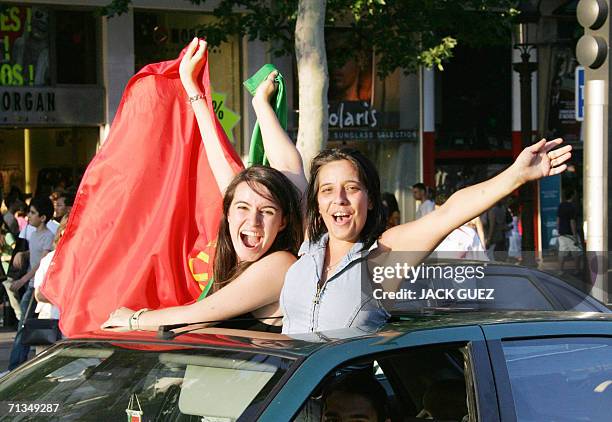 Portuguese supporters hold the national flag at the end of the World Cup 2006 quarter final football game England vs. Portugal, 01 July 2006 on...