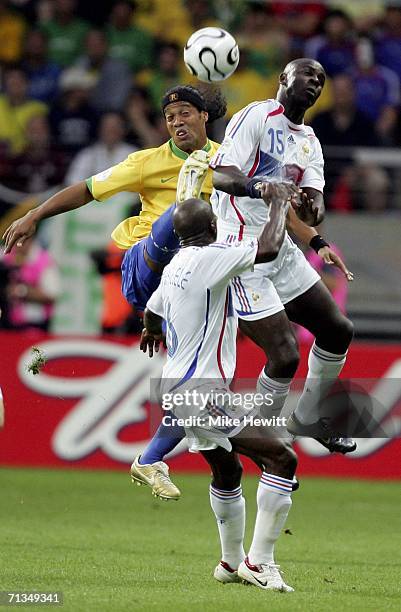 Ronaldinho of Brazil competes for the ball with Lilian Thuram of France during the FIFA World Cup Germany 2006 Quarter-final match between Brazil and...