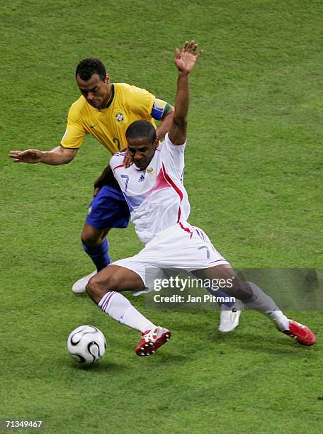 Cafu of Brazil battles with Florent Malouda of France for the ball during the FIFA World Cup Germany 2006 Quarter-final match between Brazil and...