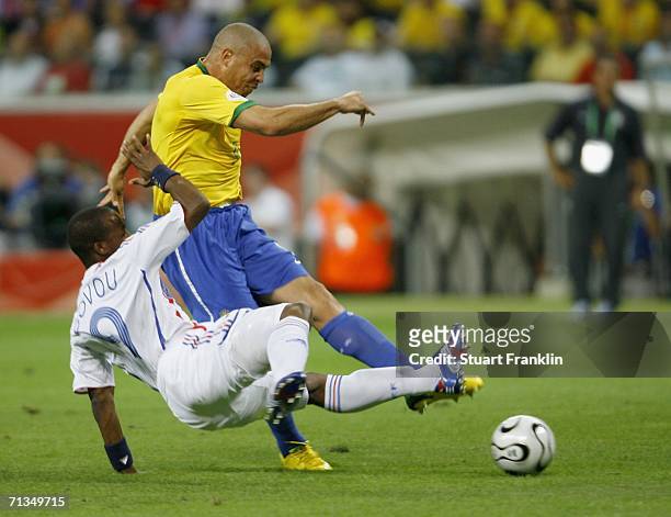 Ronaldo of Brazil shoots on goal, as he is challenged by Sidney Govou of France during the FIFA World Cup Germany 2006 Quarter-final match between...