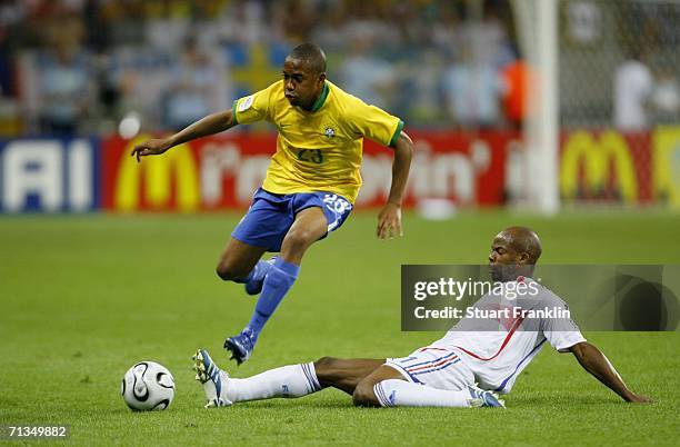 Robinho of Brazil hurdles the tackle from Lilian Thuram of France during the FIFA World Cup Germany 2006 Quarter-final match between Brazil and...
