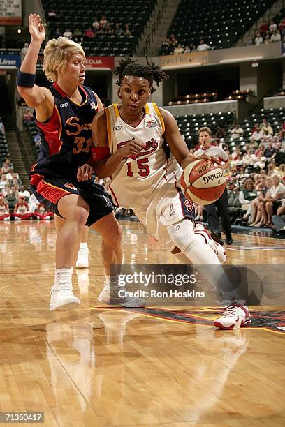 Tan White of the Indiana Fever drives on Erin Phillips of the Connecticut Sun on July 1, 2006 at Conseco Fieldhouse in Indianapolis. Indiana. NOTE TO...