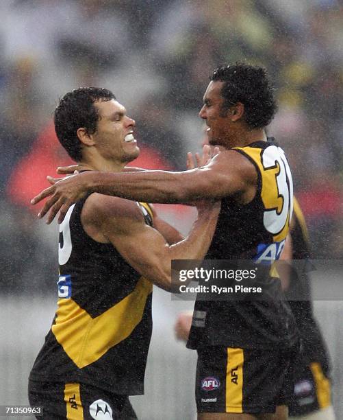 Richard Tambling and Andrew Kellaway of the Tigers celebrate a goal during the round thirteen AFL match between the Richmond Tigers and the...