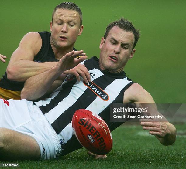 Nathan Brown for Richmond and James Clement for Collingwood in action during the round 13 AFL match between Richmond and Collingwood at the Melbourne...