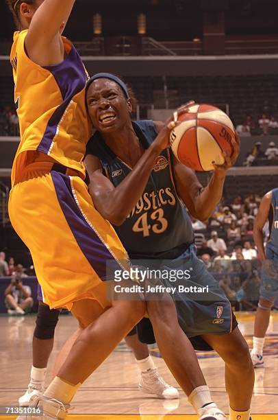 Nakia Sanford of the Washington Mystics drives to the hoop against Christi Thomas of the Los Angeles Sparks at the Staples Center on July 1, 2006 in...