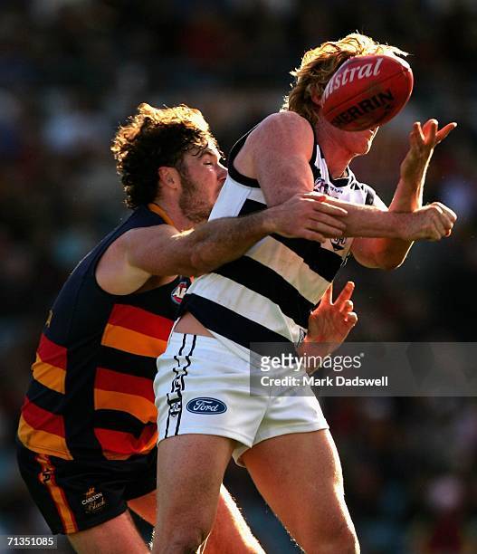 Ken McGregor of the Crows attempts to spoil Cameron Ling of the Cats during the round 13 AFL match between Adelaide and Geelong at AAMI Stadium July...