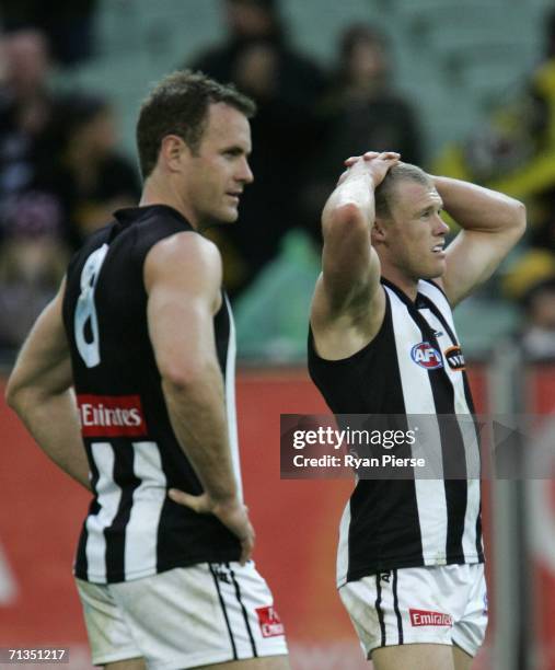 Tarkyn Lockyer and James Clement of the Magpies look dejected after the round thirteen AFL match between the Richmond Tigers and the Collingwood...