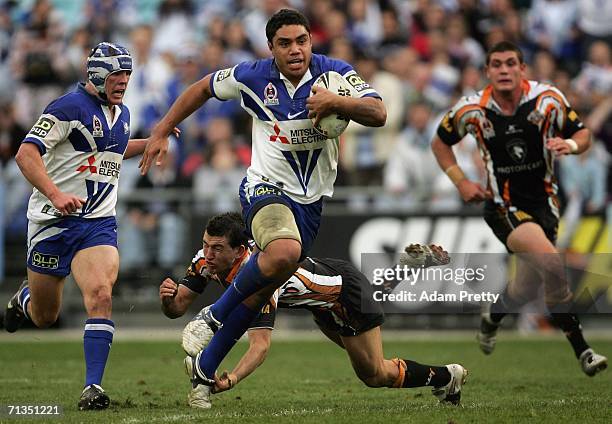 Willie Tonga of the Bulldogs on his way to scoring his try during the round 17 NRL match between the Wests Tigers and the Bulldogs at Telstra...