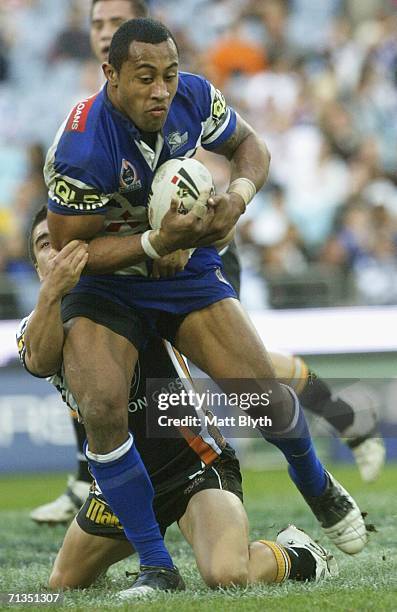 Roy Asotasi of the Bulldogs is tackled during the round 17 NRL match between the Wests Tigers and the Bulldogs at Telstra Stadium July 2, 2006 in...