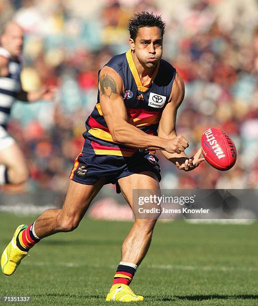 Andrew McLeod of the Crows handpasses the ball during the round 13 AFL match between the Adelaide Crows and the Geelong at AAMI Stadium on July 2,...
