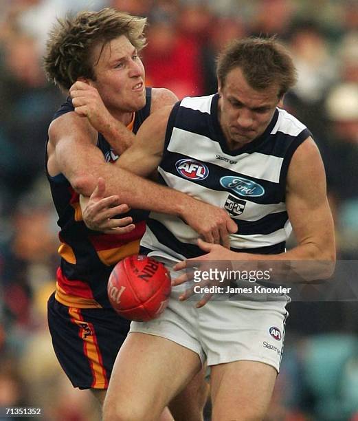 Darren Milburn of Geelong and Trent Hentschel of the Crows during the round 13 AFL match between the Adelaide Crows and the Geelong at AAMI Stadium...