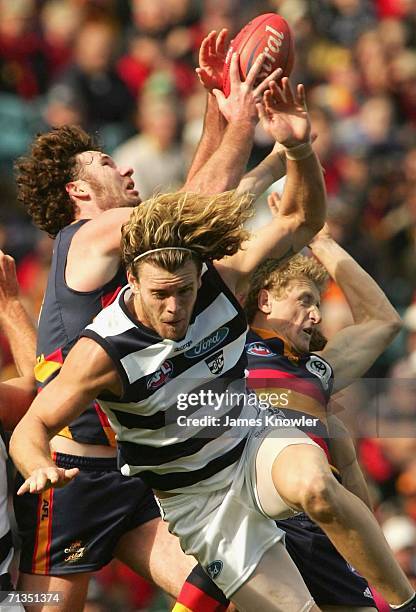 Ken McGregor of the Crows marks the ball over Cameron Mooney of the Geelong during the round 13 AFL match between the Adelaide Crows and the Geelong...