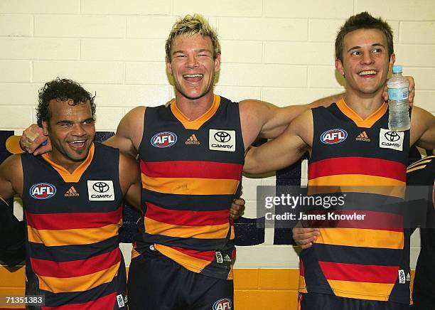 Graham Johncock, Rhett Biglands and Ivan Maric of the Crows singing the club song after winning the round 13 AFL match between the Adelaide Crows and...