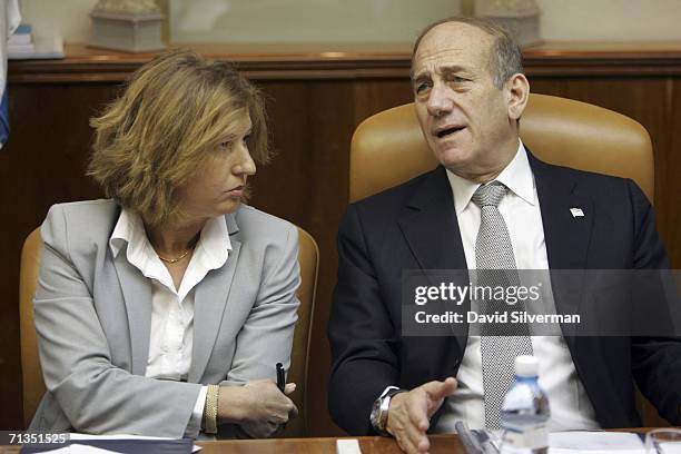 Israeli Prime Minister Ehud Olmert speaks to Foreign Minister Tsipi Livni at the start of the weekly cabinet meeting on July 2, 2006 at his office in...