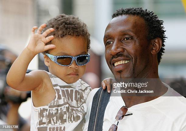 Former sprinter Linford Christie and his son pose for photographs at the Bob The Builder - Built To Be Wild UK Premiere at the Odeon West End in...