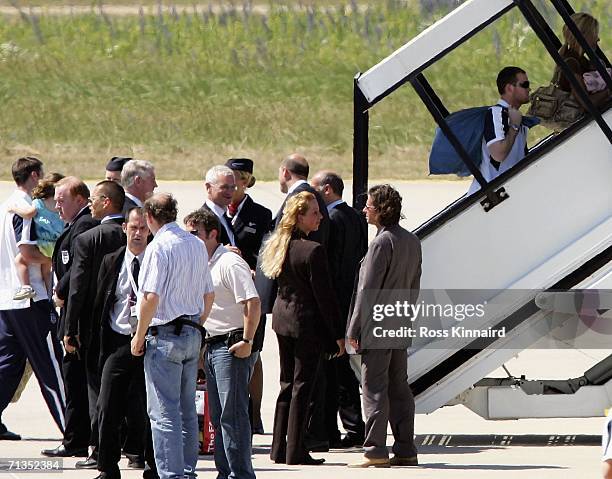 Wayne Rooney and other England players with their families make their way on to the plane at Baden-Baden airport on July 2, 2006 in Baden-Baden,...