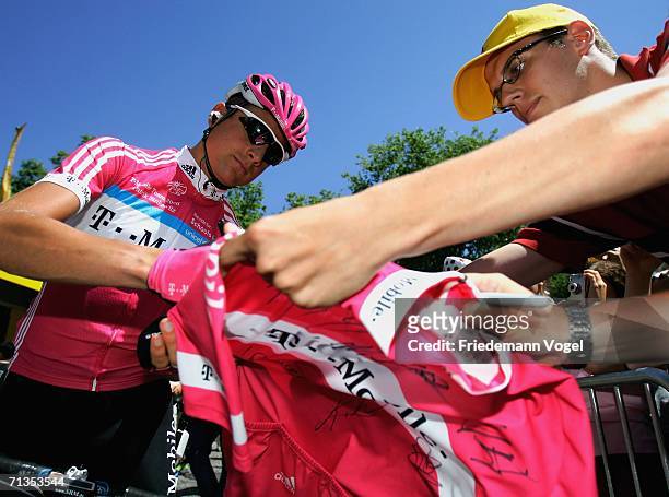 Patrik Sinkewitz of Germany and the T-Mobile Team sign a shirt before Stage 1 of the 93rd Tour de France between Strasbourg and Strasbourg on July 2,...