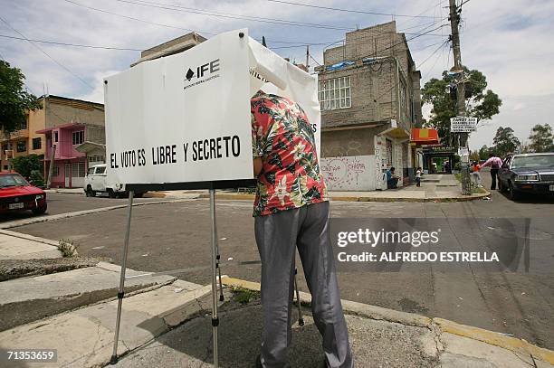 Man votes 02 July, 2006 during the general elections in Mexico in a polling booth installed in a street of Nezahualcoyotl, state of Mexico. Mexicans...