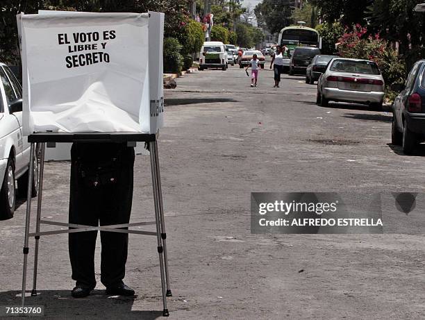 Man votes 02 July, 2006 during the general elections in Mexico in a polling booth installed in a street of Nezahualcoyotl, state of Mexico. Mexicans...