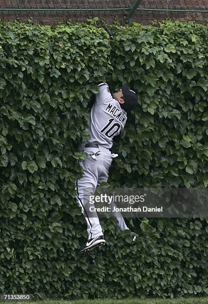Rob Mackowiak of the Chicago White Sox hits the center field wall after trying to catch a home run ball hit by Angel Pagan of the Chicago Cubs in the...