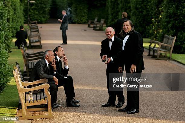 Mansour Bahrami and Henri Leconte enjoy a cigar while Barry McGuigan shares a laugh with Ilie Nastase at the ?Summer Tennis Soiree with the Stars?...