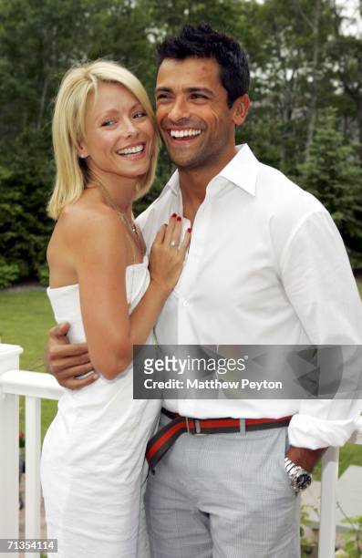 Host Kelly Ripa and her husband Mark Consuelos pose at the party to celebrate Ripa appearing as the cover of the latest Hamptons Magazine at Cain...